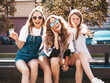 © halayalex - Portrait of three young beautiful smiling hipsters in trendy summer clothes. Sexy carefree women posing on the street background.Positive models having fun in sunglasses.Hugging
