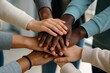 © diproduction - Diverse group of people stacking hands together in unity, symbolizing teamwork, support, and cooperation on a blurred indoor background. Ai generative