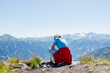 © Elena Medoks - Hiker contemplating breathtaking mountain view in summer