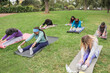 © DisobeyArt - Multigenerational women doing yoga exercises outdoor at city park - Healthy lifestyle and sport concept - Main focus on african senior woman face