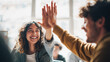 © Broccolini - A high-quality lifestyle photo of two happy young startup employees giving a high five during a meeting, celebrating success and teamwork in a bright, modern office environment.