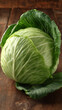 © Shahazadi - A large head of green cabbage on a wooden table or cutting board surface