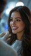 © Enggal Pitoyo - A woman smiles during a dental checkup, her teeth gleaming brightly.  The dentist's gloved hand is visible near her mouth