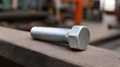 © Thares2020 - A shiny metal bolt rests on a weathered rusty industrial surface with a blurred background