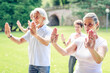 © Westend61 - Group of seniors doing Tai chi in a park