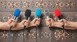 © Md - Hands holding colorful microphones in front of a decorative wooden panel background