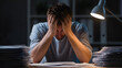 © Alexey - Stressed caucasian man sitting at desk with head in hands surrounded by paper piles. Overworked employee feeling burnout and frustration concept.