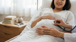 © tonstock - Pregnant woman receiving attentive prenatal care from doctor using stethoscope to check health at hospital