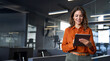 © makish - Mature adult professional business woman looking at online trade app. European businesswoman CEO holding digital tablet using fintech tab application standing at workplace in office.