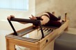 © bnenin - Pilates Reformer Exercise: Woman Stretching On Reformers In Modern Studio For Fitness And Wellness