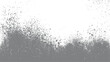 © appl - Gray spray paint splatters and dots on a white background with a dense cluster at the bottom