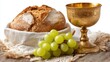 © mila103 - Freshly baked bread with golden chalice and green grapes on rustic cloth.