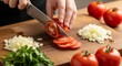 © Pro Team - Person slicing fresh tomatoes on wooden cutting board with knife and chopped onions