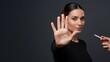 © Nataly - Woman making stop gesture, rejecting cigarette from hand against dark background. Decisive stop smoking action illustrates personal willpower and commitment to healthy living.