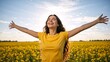 © Vasiliy - Happy young woman with arms open in a field of yellow flowers. Freedom and joy concept during summer sunset. Cheerful female enjoying nature and sunlight