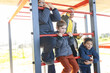 © KONSTANTIN SHISHKIN - Children having fun playing on outdoor monkey bars