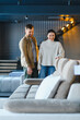 © Serhii - Couple shopping for new sofa in furniture store