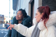 © tetxu - Women on the street pointing in a direction on a winter day