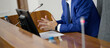 © slexp880 - Government official or business executive explaining a report at a meeting. Torso of a leader with a microphone sitting at the presidium in a hall. Photo