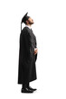 © Ljupco Smokovski - Full length shot of a man in a black graduation gown and cap looking up