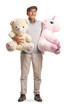 © Ljupco Smokovski - Smiling senior man standing with a teddy bear and a unicorn toy