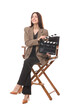 © New Africa - Professional film director with clapperboard on chair against white background