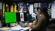 © DC Studio - Green screen next to black female expert checking social media content, video editing with dual monitors in office. Woman enhancing visibility, engagement and reach for branding. Camera A.