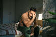 © Miljan Živković - Man experiencing headache, stress and fatigue in bedroom