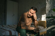 © Miljan Živković - Man experiencing headache and stress sitting in bedroom