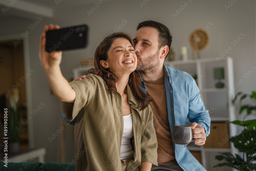 Happy loving couple taking selfie at home Stock Photo | Adobe Stock