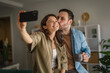 © Miljan Živković - Happy loving couple taking selfie at home
