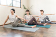 © buritora - Women doing yoga and pilates in a yoga studio or yoga class (sports gym)