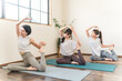 © buritora - Women doing yoga and pilates in a yoga studio or yoga class (sports gym)