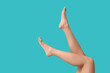 © Pixel-Shot - Legs of beautiful young woman after depilation on turquoise background