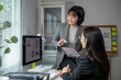© Wasana - Asian businesswomen discussing and analyzing data in office using digital tablet and computer
