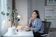 © Wasana - Asian businesswoman working with desktop computer in modern office