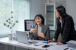 © Wasana - Asian businesswomen discussing work using laptop in office