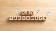 © StocksJust4You - Wooden cubes spelling 'Key Takeaways' on desk