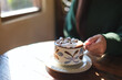 © Farknot Architect - Closeup image of a woman holding a cup of hot chocolate with marshmallow on wooden table