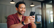 © WesJVR/peopleimages.com - Home, smile and man with smartphone for app, comment or typing on social media forum on weekend. Mobile, platform and happy person in house for communication, online chat or response on message board