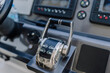 © Raivo - Boat throttle control lever with buttons and gauges in a modern marine dashboard, featuring a sleek design and metallic finish for navigation and operation