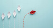 © Texture center - Red paper boat changing direction from white boats on blue background