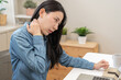 © KMPZZZ - Body muscles hurt stiff, face suffering asian young woman, girl neck pain, body ache while sitting work at home, holding massaging rubbing back, problem health care of office syndrome people concept.