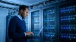 © Aqeela - Dedicated system administrator analyzes network performance using a laptop in a server room environment