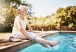 © BuyoutReese07/peopleimages.com - Smile, sunny and elderly woman at pool with break, positive attitude or weekend enjoyment in retirement. Happy, bokeh or senior person in backyard with good mood, calm or Sunday rest with fresh air.