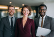 © ray - Corporate team portrait diverse three smiling professional business people in office workspace. Mature female woman leader CEO boss manager with arms crossed standing with colleagues holding gadgets