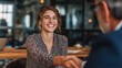 © ray - The young HR manager shakes hands with the client and the human resources manager, welcoming the newly recruited employee. The female business manager extends her greetings after signing the contract