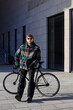 © makedonski2015 - A young brutal man in sunglasses went for a bike ride on a sunny winter day