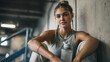 © Shahazadi - A young woman takes a break from her workout and sits on the floor with a water bottle