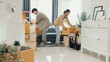 © tirachard - Young Asian couple help each other moving carton box full of stuff get some rest sit on sofa couch in living room at new house. Husband and wife move new house, Apartment Rent And Ownership Concept.